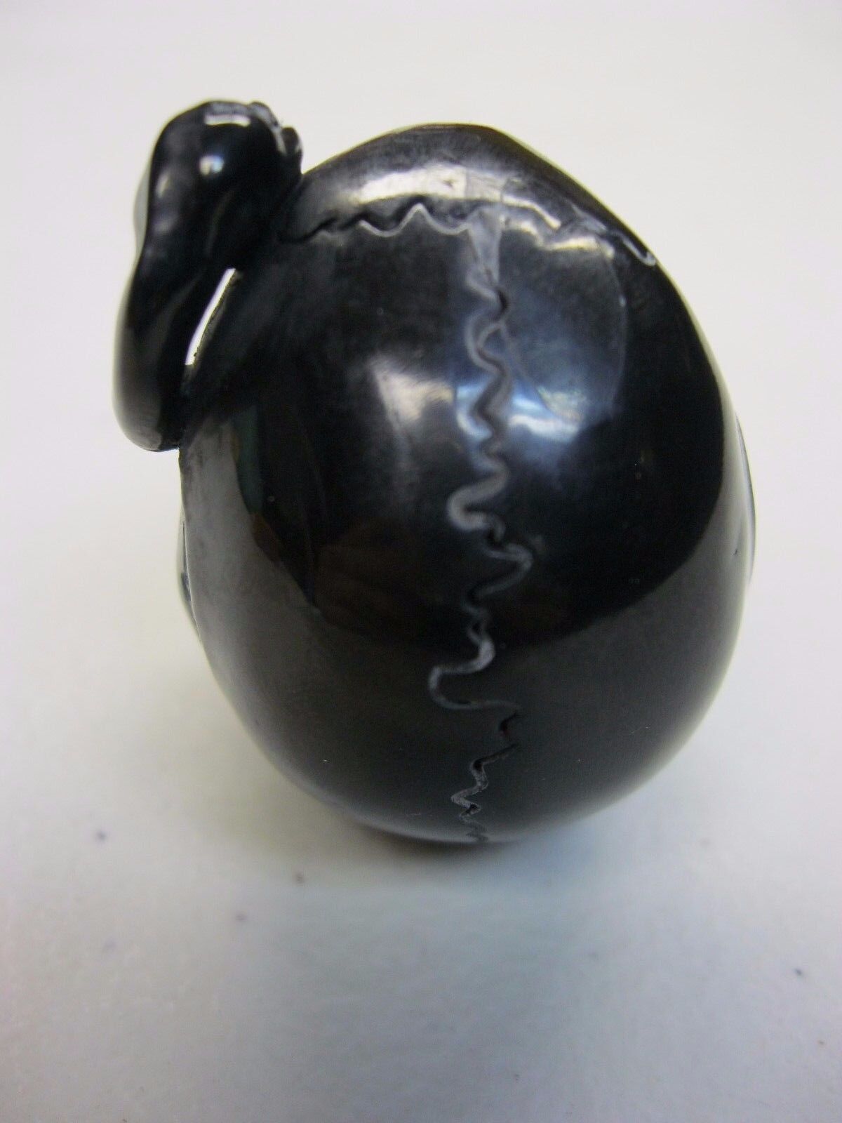 NATURAL WATER BUFFALO HORN HAND CARVED HUMAN SKULL AND SNAKE APPROX 1-1/2"